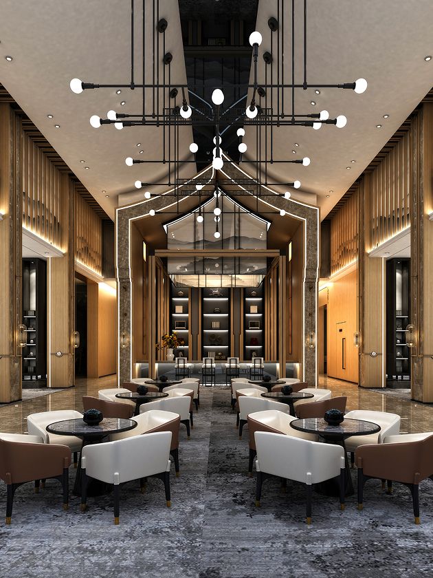 Modern hotel lobby with tall ceilings, geometric light fixtures, and symmetrical design. White and beige armchairs surround round black tables on a patterned floor, with wooden paneling and shelves in the background.
